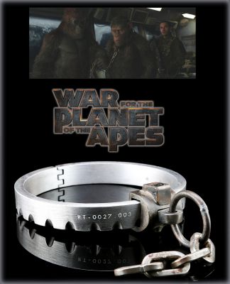 Caesar's (Andy Serkis) Prisoner Collar
Caesar's (Andy Serkis) prisoner collar from Matt Reeves' science fiction film, War for the Planet of the Apes. In this final film of the Planet of the Apes trilogy, Caesar and the other apes are caught in a conflict with humans. Caesar is seen being restrained with a collar similar to this one throughout his confinement at The Colonel's (Woody Harrelson) confinement camp for apes. The collar is milled from aluminum and has a faux lock joining the two half-circle pieces. These half-circles are hinged so they may open and close and snap together via magnets inside of the faux lock. An identifying number is painted on one side of the piece and a portion of chain is attached to the faux lock. 
Keywords: Caesar's (Andy Serkis) Prisoner Collar