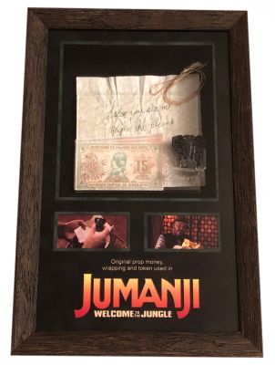 Elephant Token, Note, and Money
Four teenagers are sucked into a magical video game, and the only way they can escape is to work together to finish the game. From the 2017 fantasy film Jumanji: Welcome to the Jungle, this is the Elephant token and note seen when Spencer (Dwayne Johnson)  retrieves the actual elephant token along with a handwritten note about clues not being what they seem and to climb when they see the elephant. The missing Elephant game piece was Alan Parrishâ€™s (Robin Williams) game piece from the original film which was a notable reference to the first film as a tribute to its lead actor Robin Williams. Also in the display are different dominations of money from the Jumanji World.
Keywords: Elephant Token, Note and Money