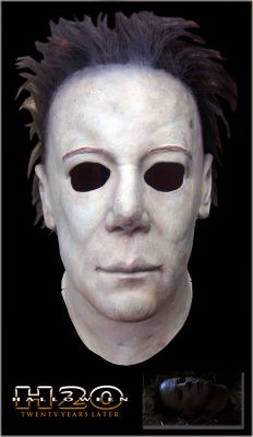 Michael Myers Mask
Laurie Strode, now the dean of a Northern California private school with an assumed name, must battle the Shape one last time and now the life of her own son hangs in the balance. This is one of two Stan Winston Michael Myers masks used in the 1998 film Halloween H20 and the actual mask seen in the film when Michael is decapitated. This mask can be seen in the finale when the police come and put Michael's corpse in a body bag, loading it into a coroner's van. Laurie, knowing that Michael is extremely difficult to kill and not believing that he is really dead, grabs the ax from earlier and an officer's gun, and she steals the van. While driving away, Michael sits up and escapes the body bag. She slams on the brakes, throwing him through the windshield. She then tries unsuccessfully to run him over. The vehicle tumbles down a cliff but she escapes, while Michael gets pinned between the van and a tree. Laurie recovers the axe and approaches him. He reaches out to her, apparently seeking forgiveness and compassion. At first it seems she will accept this, and begins reaching out to him, but then she slowly pulls her hand back and decapitates Michael, finally killing him. 
Keywords: Michael Myers Mask