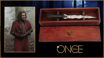 Rumplestiltskin's (Robert Carlyle) Dark One Dagger
A young woman with a troubled past is drawn to a small town in Maine where fairy tales are to be believed. From the TV series once Upon a Time, this is Rumplestiltskinâ€™s (Robert Carlyle) original hero signature character Dark One Dagger seen numerous times in the series. The dagger's main use is to stab the Dark One with it and the power of the Darkness passes to the one who kills them, causing the new host's full name to appear on the blade. Constructed of 12 in. tooled aluminum blade engraved on the face "Rumplestiltskin" with filigreed design on both sides. Attached to a 7 in. cast resin grip with a heart-shaped pommel with embedded faceted heart-shaped faux ruby and other gems in the pommel and at the hilt. One if the most important and iconic props used in the Once Upon a Time series.
Keywords: Rumplestiltskin's (Robert Carlyle) Dark One Dagger