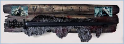 Sword of Kings
Vikings transports us to the brutal and mysterious world of Ragnar Lothbrok (Travis Fimmel), a Viking warrior and farmer who yearns to explore - and raid - the distant shores across the ocean.  From the Vikings 2019 season 5 episode 20 â€œRagnarokâ€, and seen in multiple episodes; this is the â€œSword of Kingsâ€ that was given to Bjorn Ironside (Alexander Ludwig) by Lagertha (Katheryn Winnick) for defeating Ivar and becoming the King of Kattegat. Whoever is the rightful monarch possesses this to symbolize his power, and is akin to scepters or regalia used by real world sovereigns. The Sword of Kings is long, with a brown-colored handle and hilt, and a distinctive blade. The hilt of the sword is adorned with precious jewels and etched with Viking runes that translate to "Sword of kings". Whilst attacking Kattegat, King Horik showed the sword to his son, Erlendur, saying that if the gods willed it, he would one day possess it as his son. After killing Horik, King Ragnar oversaw his new domain on a high cliff, symbolizing his newfound monarchical status. Lagertha assumed the sword from Aslaug shortly before she killed her in revenge for taking Ragnar as her ex-husband. Shortly after the Siege of Kattegat, Lagertha gives the sword to her son Bjorn and proclaims him King of Kattegat. He later oversees his kingdom on a high cliff while holding the sword, as his father (who appears to him as a draugr) did before him. The Sword of Kings is a ceremonial sword, signifying the power and authority of the King of the Danes. It is currently in the possession of King BjÃ¶rn Ironside. 
Keywords: Sword of Kings