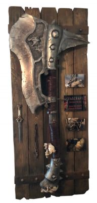 Frostwolf Orc Axe, Garonaâ€™s Dagger, and Tusk Necklace
As an Orc horde invades the planet Azeroth using a magic portal, a few human heroes and dissenting Orcs must attempt to stop the true evil behind this war. From the 2016 video game adaption Warcraft, this is a display of pieces used in the film including a Frostwolf Orc Axe, Garonaâ€™s dagger, and tusk necklace. Frostwolf Orcs were a clan of Orcs led by Durotan that used their axes while in battle throughout the film while Garona Halforcen (Paula Patton) is a strong-willed half-orc caught between the war of orcs and humans. Garona was born to an orcish woman who had mated with a young Medivh for which the mother was burned alive. The child would have been killed; had not Gul'dan intervened taking the child as a slave. A half-breed, small and weak in comparison to the other orcs, the warlock would give her the name "Garona", meaning "Cursed". Gul'dan did however also give Garona one of her mother's tusks to remember her by. Later in the film Garona gives Lothar her necklace in his prison cell, before going off to fight with the Alliance. Garona used her knife to defend herself against Orcs, and later to kill King Llane in the hopes of bringing peace to Azeroth.
Keywords: Frostwolf Orc Axe, Garonaâ€™s Dagger, and Tusk Necklace