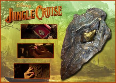 Arrowhead Artifact with Gem

Based on Disneyland's theme park ride where a small riverboat takes a group of travelers through a jungle filled with dangerous animals and reptiles but with a supernatural element. Lily Houghton (Emily Blunt) is determined to uncover an ancient tree with unparalleled healing ability possessing the power to change the future of medicine. From the 2021 Disney film Jungle Cruise, this is the screen used Arrowhead with the small gem inside. Discovering the arrowhead is a locket with a red gem inside, Lily places the two pieces into carvings in the bark and the Tree briefly blooms under the blood moon. Being the gem inside the Arrowhead was created gold colored, it was added in post to be colored red by CGI.
Keywords: Arrowhead Artifact with Gem