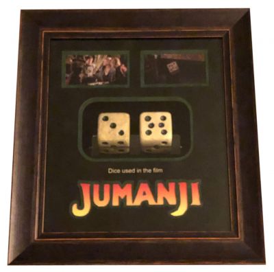 Oversized (Smaller Scale) Insert Dice
When two kids find and play a magical board game, they release a man trapped for decades in it and a host of dangers that can only be stopped by finishing the game.  This is a set of dice from Joe Johnston's adventure film Jumanji. Different scale dice were made and used for close-up and insert shots of the dice rolling. This set is made of foam urethane, the dice are creme-colored with round black indentations. This set of the smaller pair of dice show cracks to the paint, but the set remains in very fine condition and measure 1 3/4'' x 1 3/4'' x 1 3/4'' in size.
Keywords: Oversized (Smaller Scale) Insert Dice