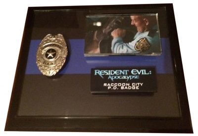 Raccoon City Police Badge
Alice awakes in Raccoon City, only to find it has become infested with zombies and monsters. With the help of Jill Valentine and Carlos Olivera; Alice must find a way out of the city before it is destroyed by a nuclear missile. This is a worn and used Raccoon City Police Badge used in the 2004 film, Resident Evil Apocalypse. The Raccoon City Police Department was the main law enforcement entity for the former midwestern town of Raccoon City, and the surrounding areas such as the nearby Arklay Mountains. The Raccoon SWAT was part of this organization, with the S.T.A.R.S. teams being an associated agency. 
Keywords: Raccoon City Police Badge